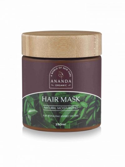 A jar of Ananda Organic Hair Mask with a wooden lid on a white background. The dark brown jar has a label reading 'Natural Moisturizing' for revitalizing severely dry hair, with a green leaf design, and contains 250ml of product