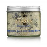 A clear jar filled with Ananda Bio Cosmetic Aromatherapy Dead Sea Natural Salt and Herbs Bath. The mixed salts and herbs are visible through the glass, labeled prominently in blue and gold text against the natural-colored background