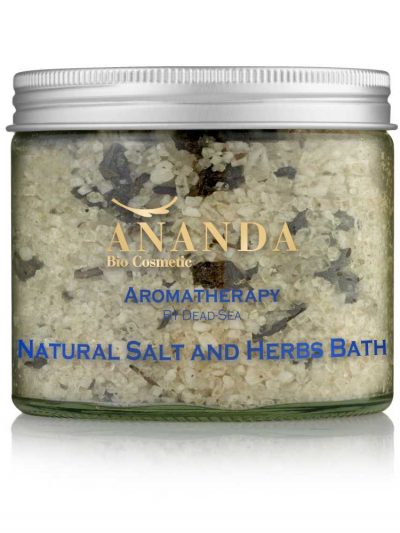 A clear jar filled with Ananda Bio Cosmetic Aromatherapy Dead Sea Natural Salt and Herbs Bath. The mixed salts and herbs are visible through the glass, labeled prominently in blue and gold text against the natural-colored background