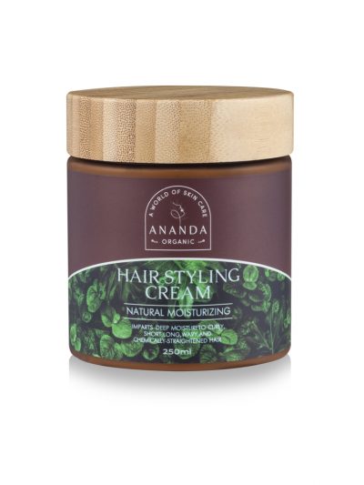 A jar of Ananda Organic Hair Styling Cream with a wooden lid on a white background. The dark brown jar is labeled 'Natural Moisturizing' and specifies it imparts deep moisture to curly, short, long, wavy, and chemically-straightened hair. The size is marked as 250ml, and the jar is adorned with a green leafy design